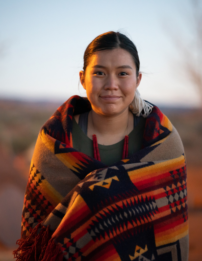 Smiling Navajo young woman portrait at dusk in Arizona